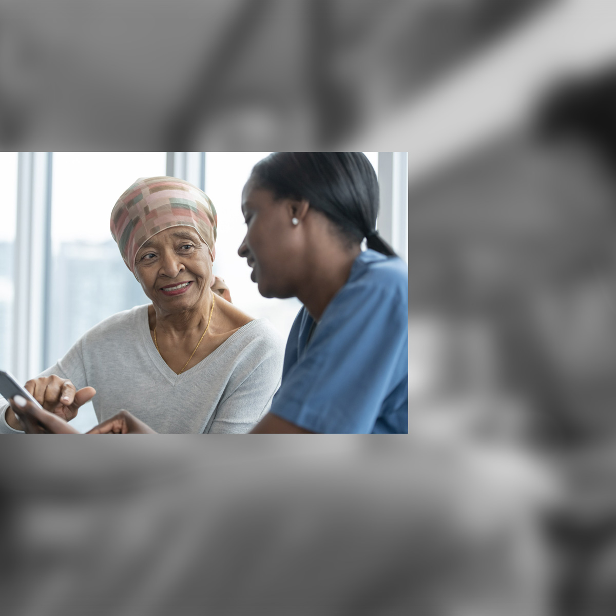 Photo of a health and care professional in consultation with another person
